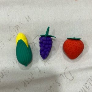A corn and grape and strawberrie erasers